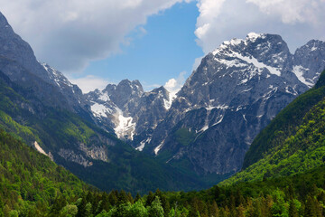Fototapeta premium Mountain Range and the peak of the Mount Mangart (2677 m) seen from Fusine Lake, Julian Alps, Tarvisio, Udine, Friuli Venezia Giulia, Italy Slovenia border, Europ