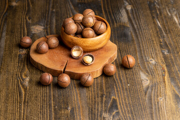 Unpeeled macadamia nuts on a wooden table