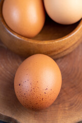 A whole orange chicken egg close-up on the table