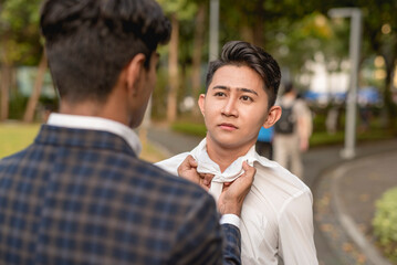 A man aggressively confronts his stubborn rival, grabbing him by the collar. Suspecting him of badmouthing or cheating with his girlfriend.