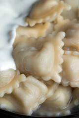Fototapeta na wymiar Sour cream covered dumplings with meat