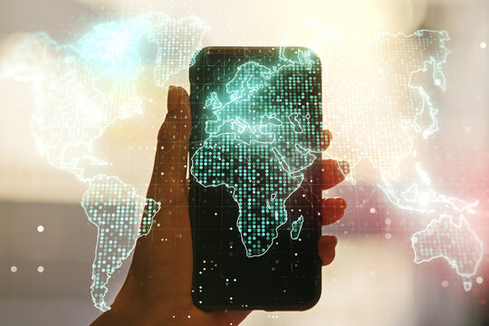 Multi exposure of abstract creative digital world map and hand with cell phone on background, research and analytics concept