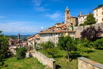 Fototapeta na wymiar Small medieval town of Monforte d'Alba under blue sky in Italy.
