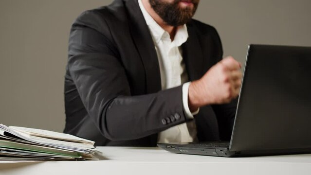Aggressive man at work, Computer failure, error, stress at work concept. Mad impulsive crazy adult guy breaks down laptop, office worker pushing monitor and keyboard