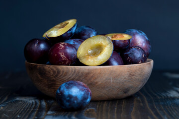 Ripe plums on the table in the kitchen