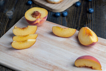 Ripe fresh peaches on a wooden table