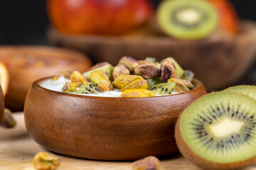 fresh green yogurt with pieces of kiwi and pistachios
