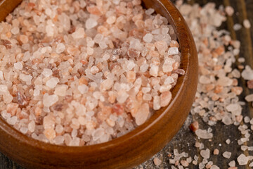 Pink natural salt on the table, close up