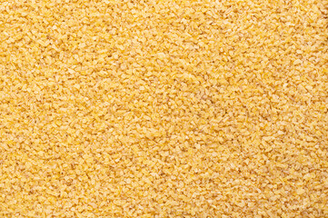 Coarse bulgur, also called burghul, surface, from above. Cracked and parboiled wheat foodstuff, and common ingredient in cuisines of West Asia and Mediterranean Basin, with a light and nutty flavor.