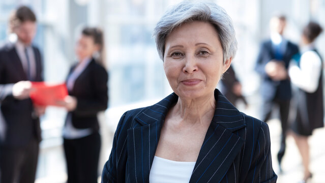 Mature businesswoman standing in office