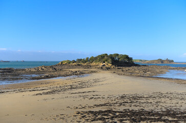 Fototapeta na wymiar View of sand beach during low tide a winter sunny afternoon, Lancieux, Brittany, north of France