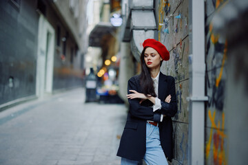 Fashion woman portrait walking tourist in stylish clothes with red lips walking down narrow city street, travel, cinematic color, retro vintage style, dramatic.