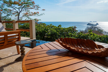 Luxury furnished resort table and bench with beautiful seascape at Costa Rica. Travel and vacation...