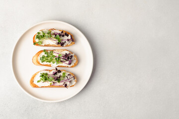 Healthy snacks or starter, appetizer with organic microgreens growing at home for healthy eating or for restaurant. Top view, copy space for text 