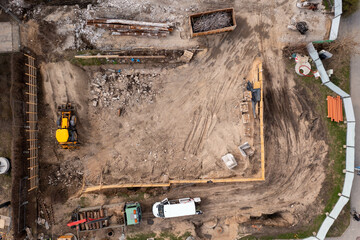 Drone photography of construction site during summer day.