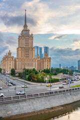 Fototapeta na wymiar High-rise stalinist building near river at summer sunset in Moscow, Russia. Historic name is Hotel Ukraine.