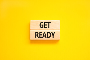 Get ready symbol. Concept words Get ready on wooden blocks on a beautiful yellow table yellow background. Business, support, motivation and get ready concept. Copy space.