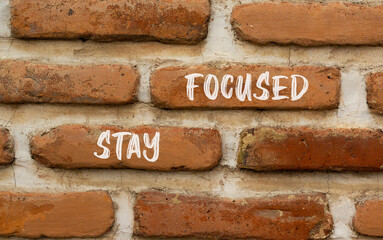 Stay focused symbol. Concept words Stay focused on beautiful brown brick wall on a beautiful brown brick wall background. Business, support, motivation, psychological stay focused concept. Copy space.