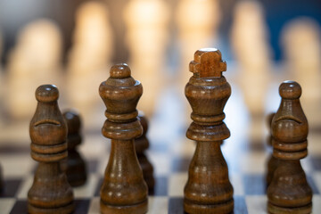 close up view of brown wooden pawns of chess game