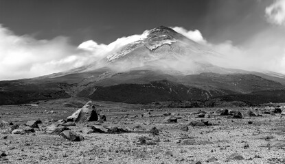 The Cotopaxi volcano, fields and meadows, rocks and moving straw, all part of a wonderful scene at the Cotopaxi National Park, Ecuador. Black and White photography. ND filters used for movement.