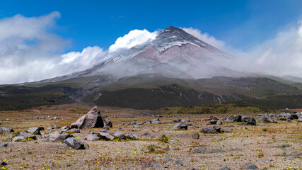 Cotopaxi volcano which has been throwing out ash, has one of its cone sides completely covered in it. Photos taken with ND filters to capture the moving clouds. National Park, Ecuador.