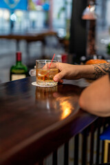 person drinking wiskey in bar