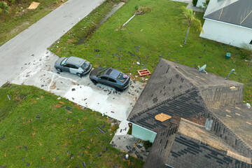Natural disaster and its consequences. Hurricane Ian destroyed house roof in Florida residential...