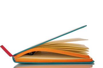 One notebook with pen, macro, isolated on white background.