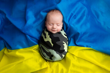newborn lies on the flag of Ukraine. little Ukrainian patriot. the first photo session of a...