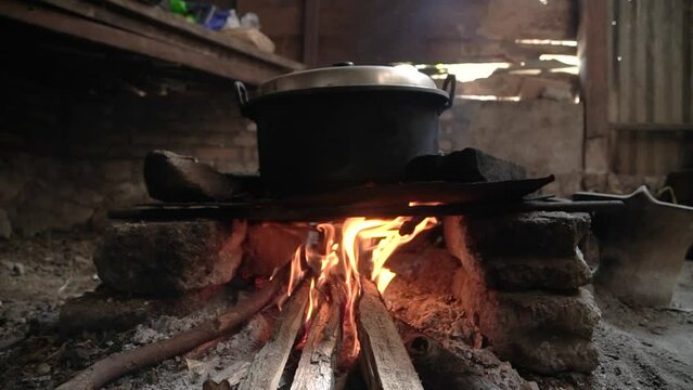 Cooking using traditional stoves in the countryside, the fuel uses wood from forest products. cooking all kinds of dishes in the traditional way with clay and wood stoves as fuel