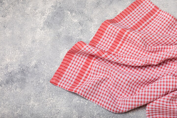 Kitchen towels on a marble background. New kitchen cotton towels on the kitchen table. Red checkered picnic napkin. Home textiles. Place for text. copy space.