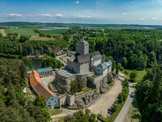 Fototapeta na wymiar Aerial view of Kost castlein Libosovice , built in high Gothic style, White Tower keep surrounded by 2 concentric walls in the Bohemian Paradise