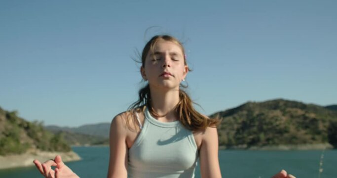 Lifestyle of a teenage girl meditating alone in nature. Children's mental problems and psychological crises in relations with parents. High quality 4k footage