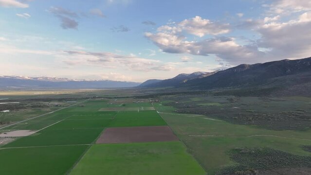 Aerial farming agriculture rural mountain valley U. Rural farming community agricultural economy. Spring summer season weather mountain valley agriculture field harvest. Seasonal. weather environment.