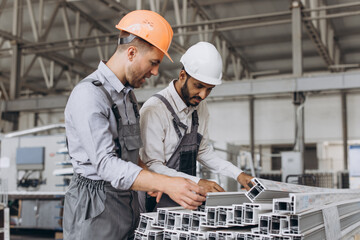 International team, manager and worker discuss cargo at window and door production.