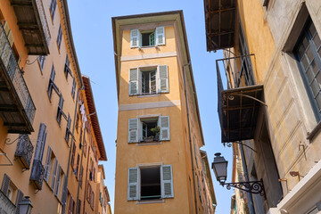 Fototapeta na wymiar Old Town of Nice city in France, narrow apartment building with shuttered windows n historical district Vieille Ville
