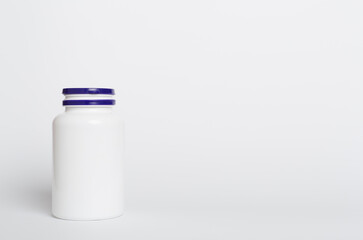 Plastic bottle for vitamins on color background