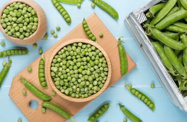 Composition with fresh green peas on wooden background, top view