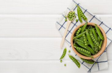 Composition with fresh green peas on wooden background, top view