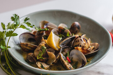 Mussels in a Green Pastel Bowl with Fresh Salsa Leaves and Peppers