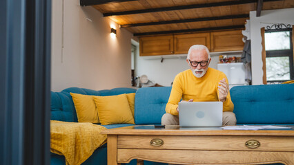 One senior caucasian man work on laptop use computer at home