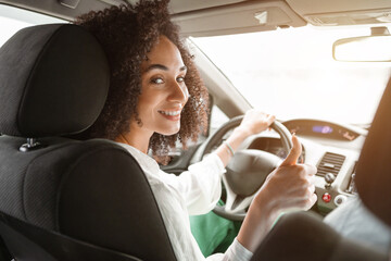 Young Middle Eastern Woman Driving New Car, Showing Thumbs Up