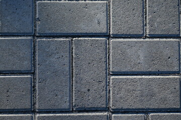 grey paving slabs as a background, symmetrical paving slabs close up 