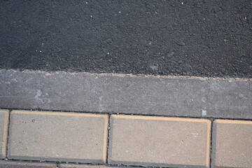 Fototapeta premium Close-up of a sidewalk and road markings, bike path, blind lane, pedestrian crossing, road texture, paving slabs