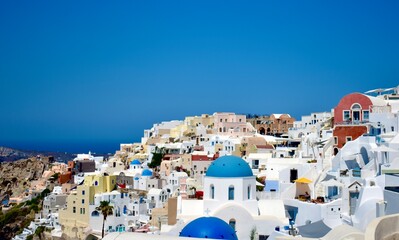 Oia buildings and blue domes on cliffside