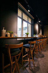 vertical interior with chairs in the office near the windowsill with snacks. Stylish modern interior