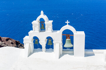 Traditional bells of white aegean church in Santorini oia Greece