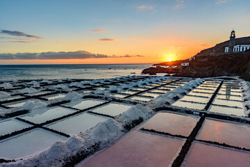 Sunset at the salt flats directly on the Atlantic coast. The sea salt shines romantically in the light