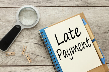 Late payment - mount of money a borrower sends to a lender that arrives after the date that the payment was due, text on a page on a notepad on a desktop