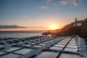 Sunset at the salt flats directly on the Atlantic coast. The sea salt shines romantically in the light